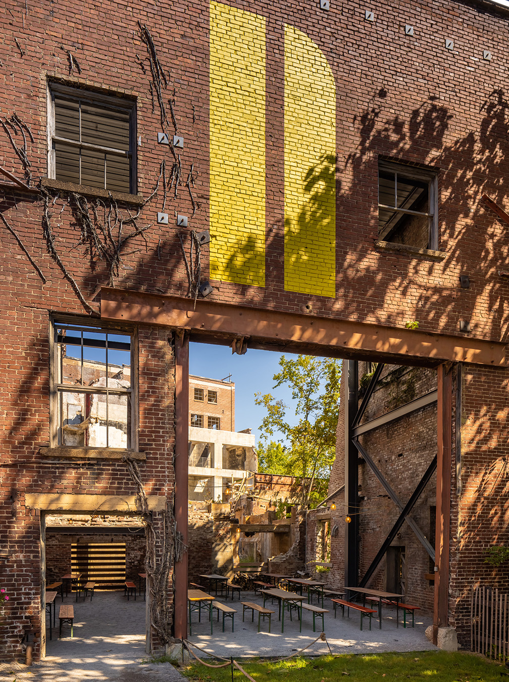 Adaptive reuse at Neuhoff — salvaged industrial brick with yellow Neuhoff mark